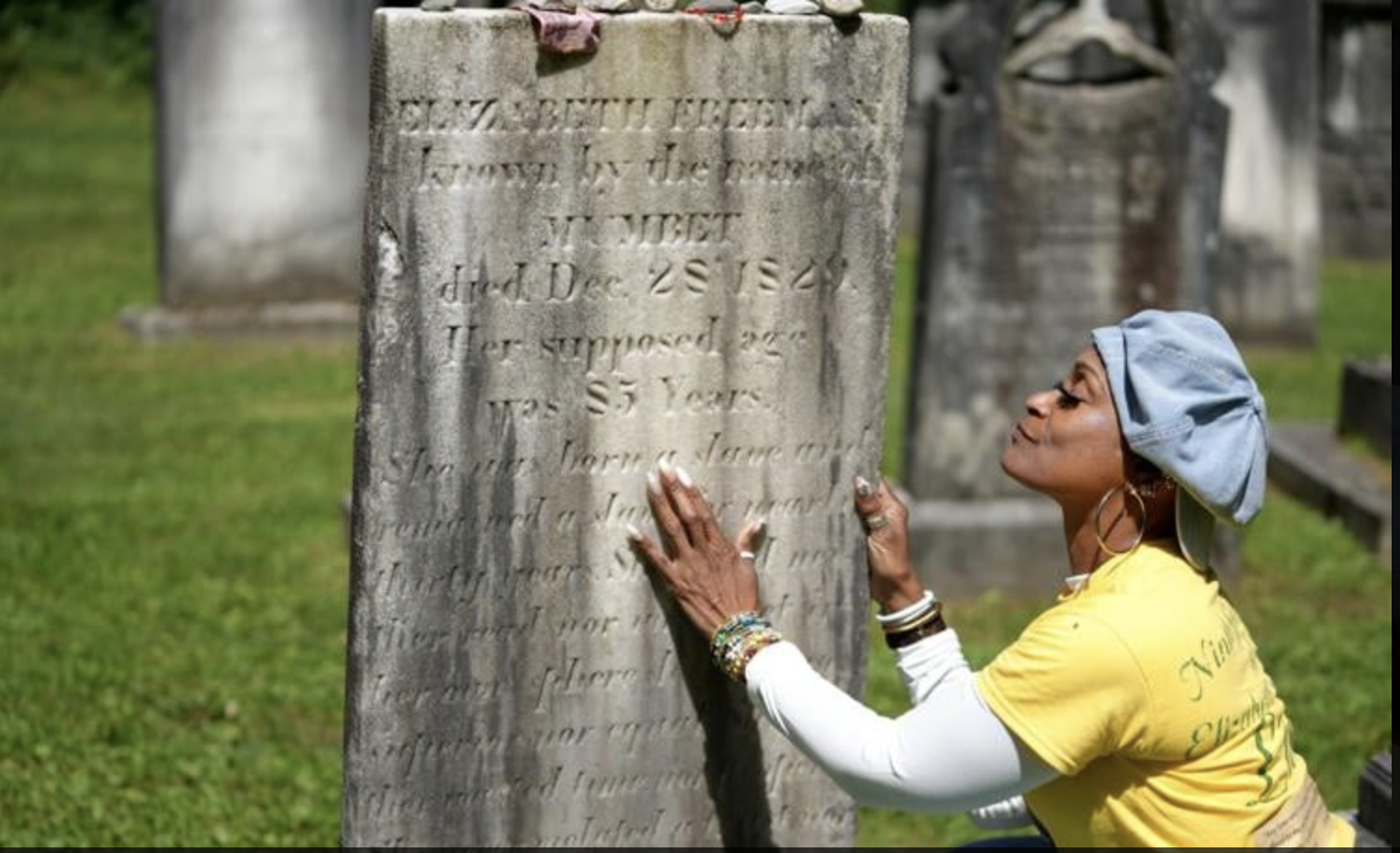 Lisa Shepperson examines Freeman's gravestone, Berkshire Eagle