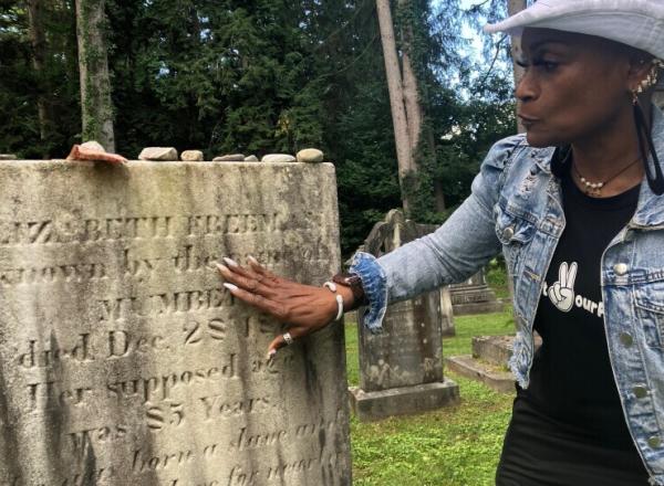 Lisa Shepperson examines Freeman's gravestone Lisa Shepperson examines Freeman's gravestone